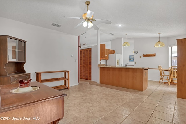 kitchen with lofted ceiling, white refrigerator with ice dispenser, ceiling fan, light tile patterned floors, and kitchen peninsula