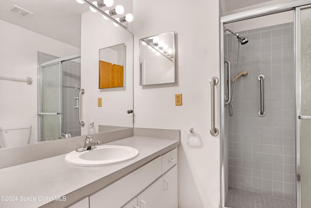 bathroom with vanity, toilet, and walk in shower