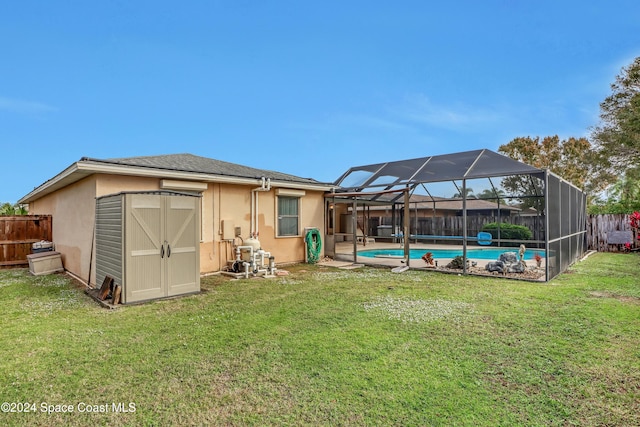 back of property with a lanai, a yard, a fenced in pool, and a storage unit