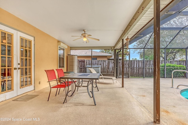 view of patio / terrace featuring ceiling fan, glass enclosure, and french doors