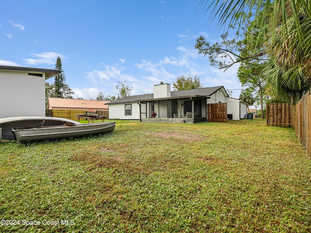 view of yard with a sunroom