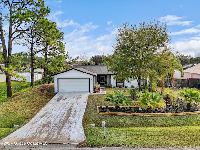 view of front of house featuring a front yard and a garage