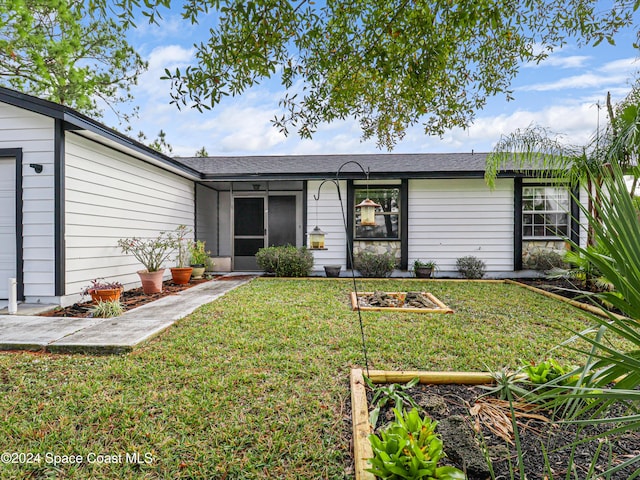 ranch-style house with a front lawn and a garage