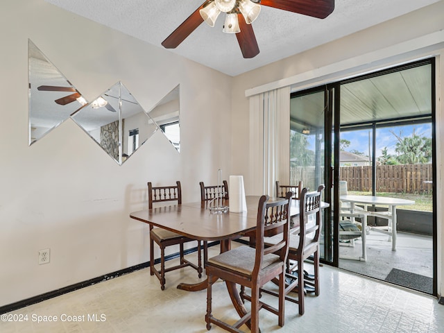 dining area featuring ceiling fan and a textured ceiling