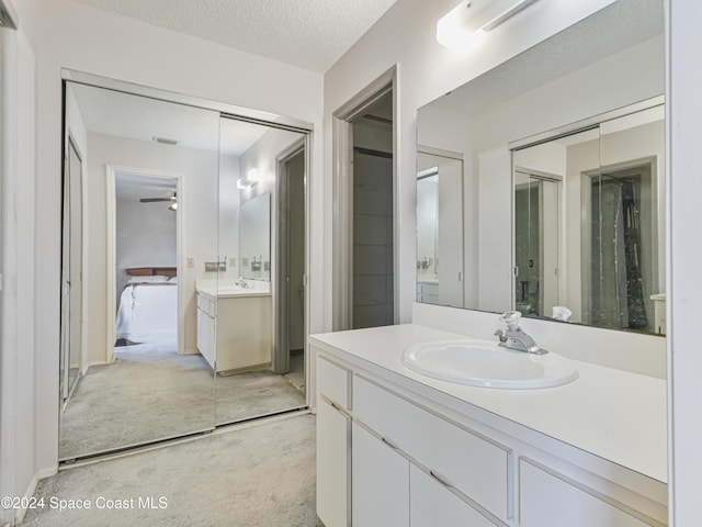 bathroom featuring vanity, a textured ceiling, and ceiling fan