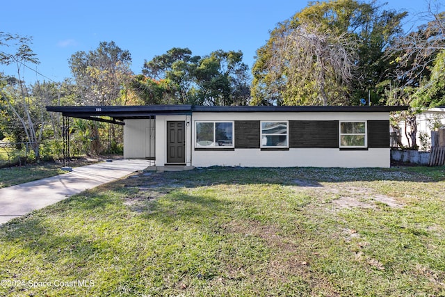 ranch-style house featuring a carport and a front lawn