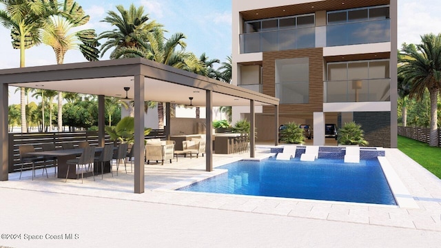 view of swimming pool with an outdoor kitchen, a patio area, and a jacuzzi