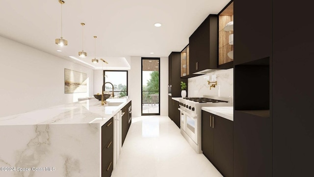 kitchen with light stone countertops, decorative backsplash, gas range, sink, and hanging light fixtures