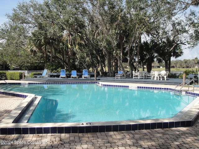 272 Aquarina Blvd Unit 272, Melbourne Beach, FL 32951 - community pool featuring view of scattered trees and a patio