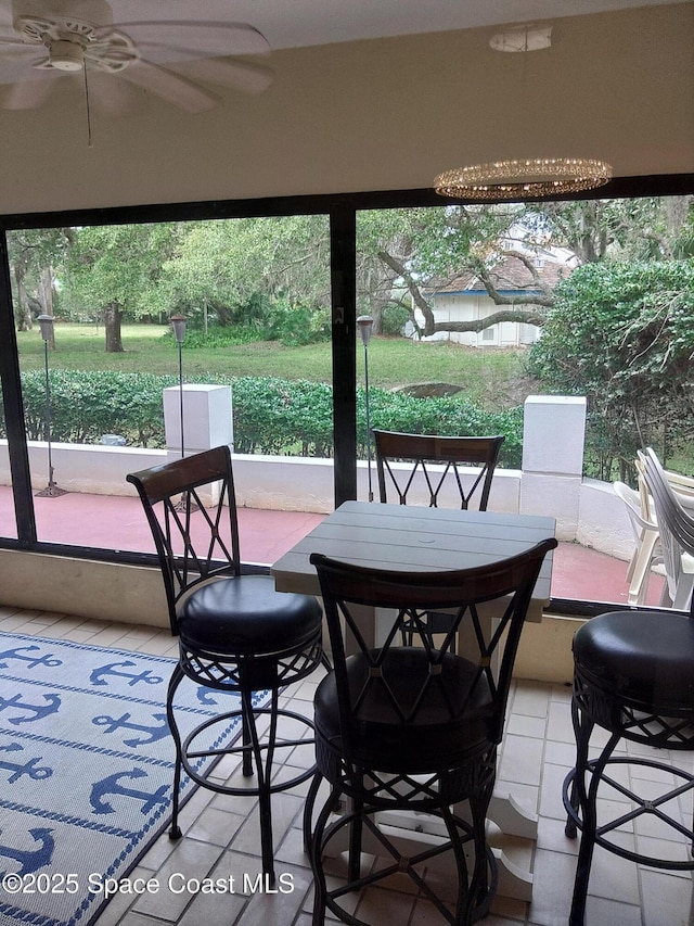 sunroom / solarium with ceiling fan and a healthy amount of sunlight