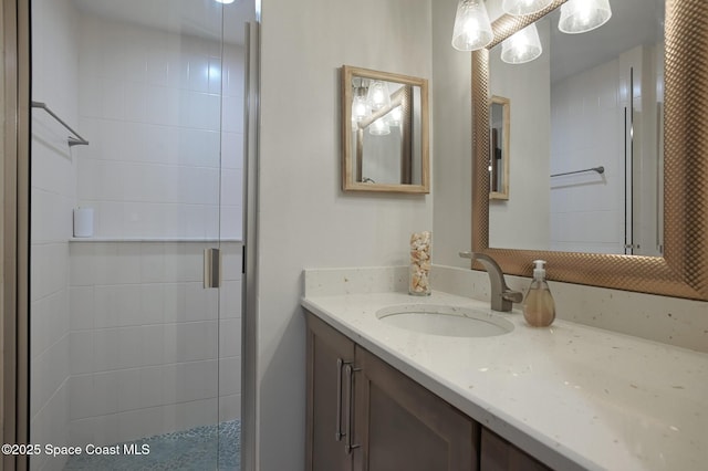 bathroom with vanity and a shower with shower door