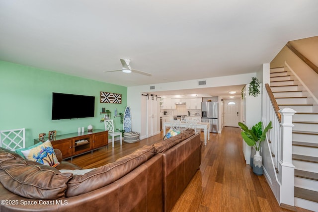 living room with ceiling fan and hardwood / wood-style flooring