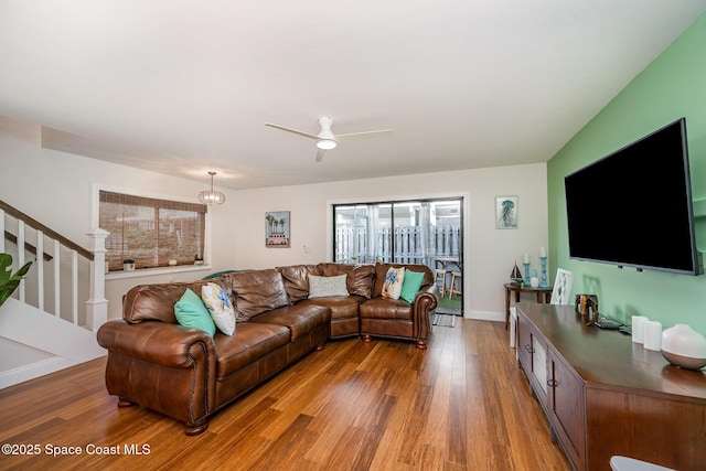 living room with ceiling fan and hardwood / wood-style flooring