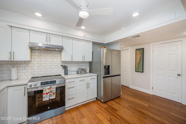 kitchen with tasteful backsplash, ceiling fan, white cabinetry, light wood-type flooring, and stainless steel appliances