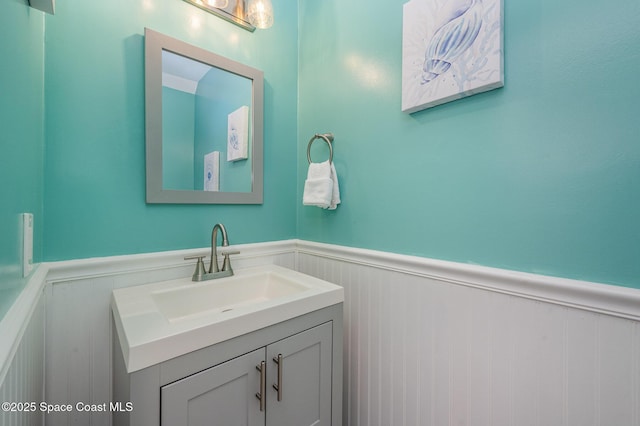 bathroom featuring a wainscoted wall and vanity