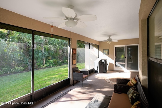 sunroom / solarium featuring a wealth of natural light and ceiling fan