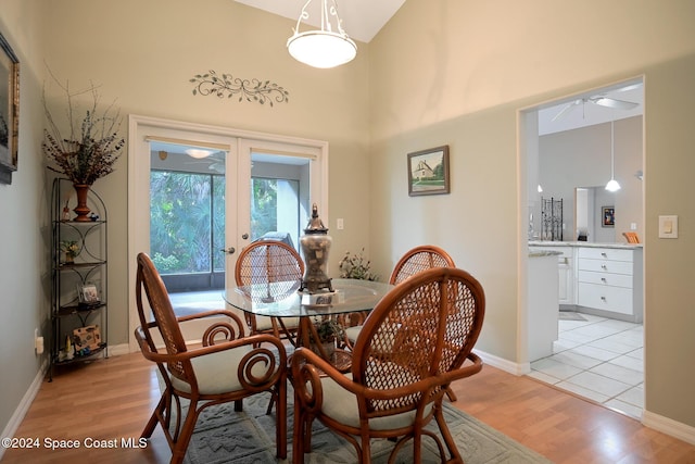 dining space featuring ceiling fan, french doors, and light wood-type flooring