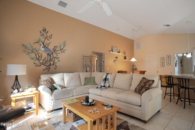 tiled living room with ceiling fan and lofted ceiling