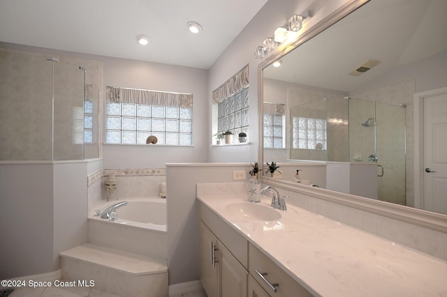 bathroom with vanity, separate shower and tub, and lofted ceiling