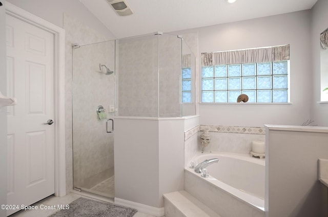 bathroom featuring tile patterned flooring and shower with separate bathtub