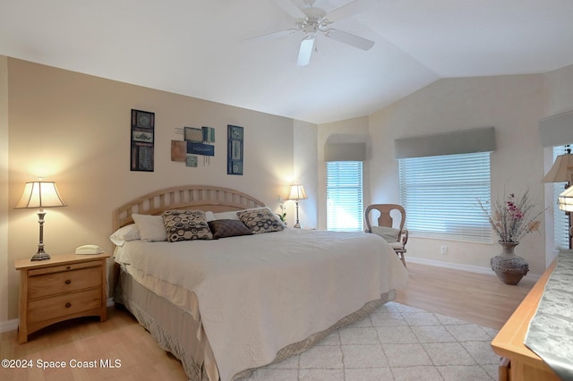 bedroom with ceiling fan, light hardwood / wood-style floors, and lofted ceiling