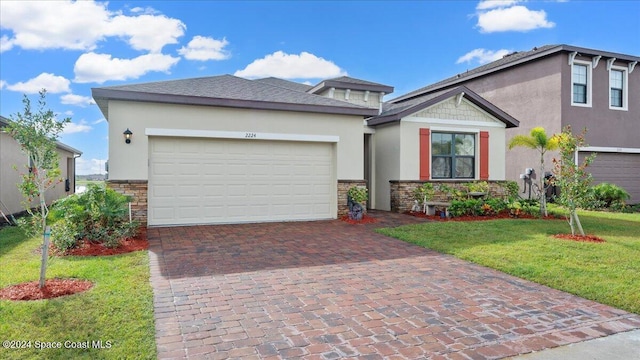 view of front of home featuring a garage and a front yard