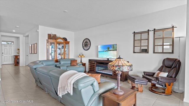 tiled living room featuring a textured ceiling