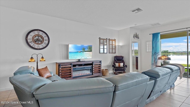 tiled living room featuring a textured ceiling