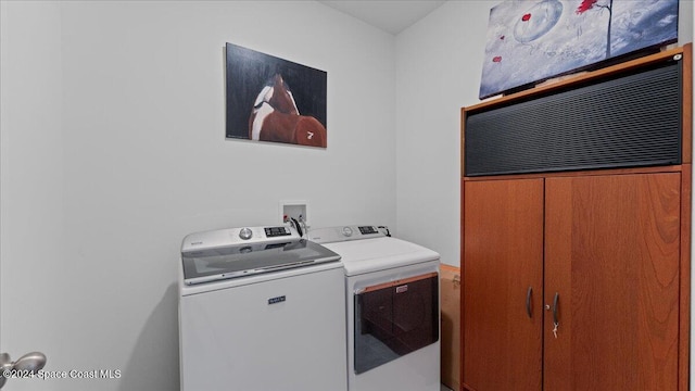 clothes washing area featuring washing machine and clothes dryer