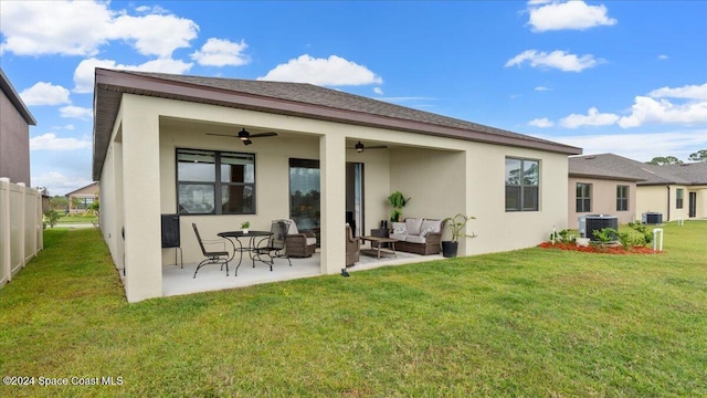 rear view of property featuring a patio, outdoor lounge area, cooling unit, a yard, and ceiling fan