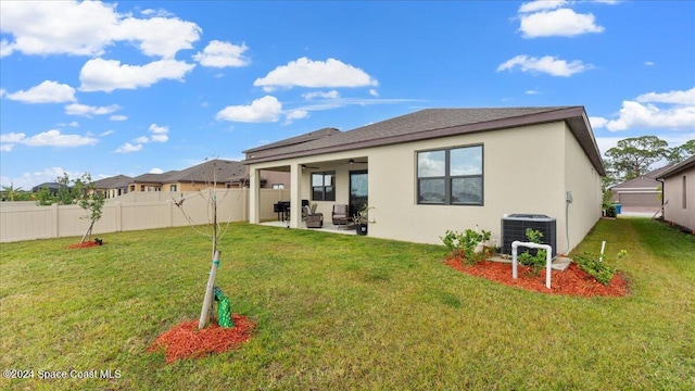 back of house with a yard, central AC, a patio, and ceiling fan