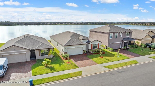 view of front facade with a front lawn and a water view