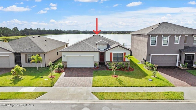 view of front of home with a water view, a garage, and a front yard