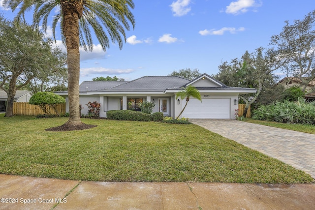 ranch-style home with a front yard and a garage