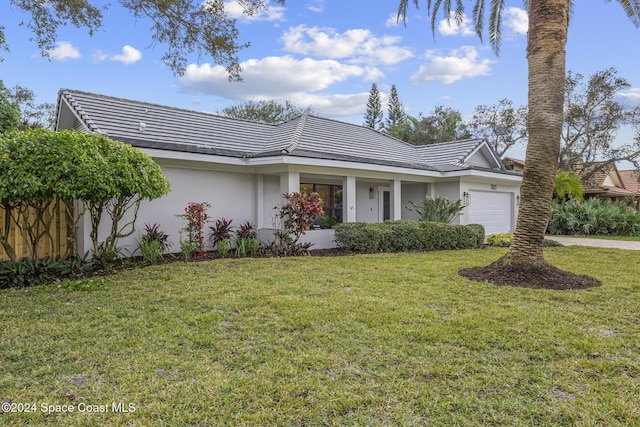 ranch-style home with a front yard and a garage