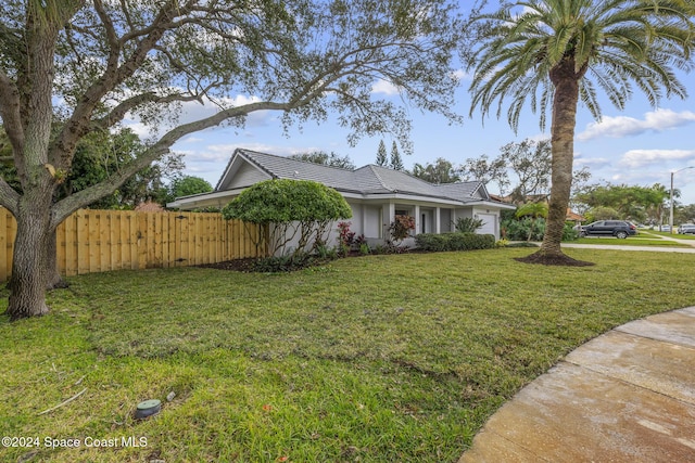 view of front of property with a garage and a front lawn