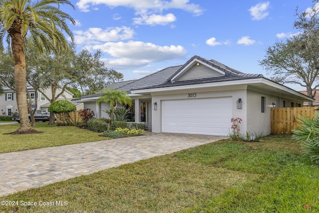 single story home featuring a front yard and a garage