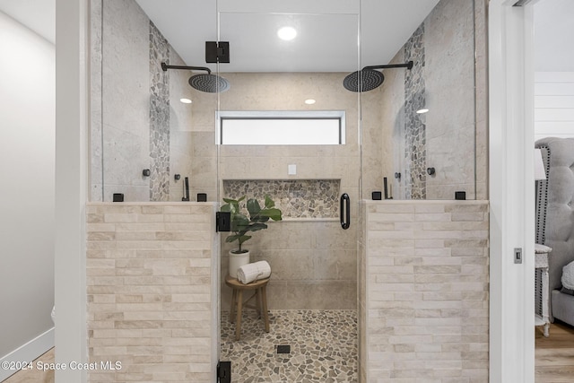 bathroom with hardwood / wood-style floors and a shower with door