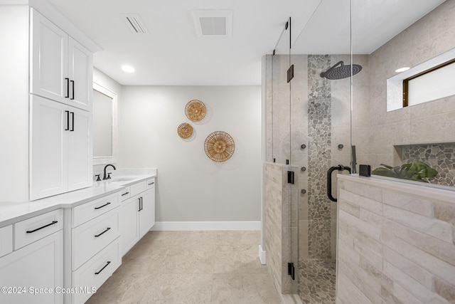 bathroom featuring vanity and a shower with door