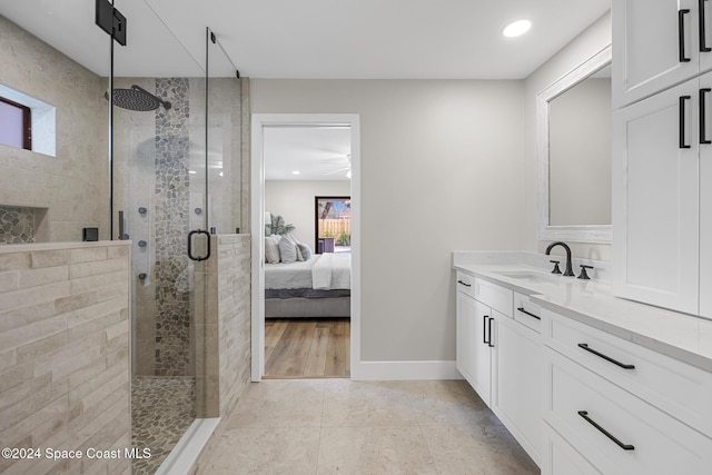 bathroom featuring tile patterned flooring, vanity, and a shower with shower door