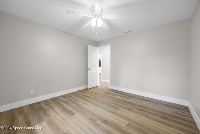 spare room featuring ceiling fan and light hardwood / wood-style floors