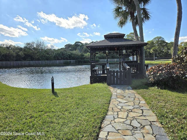 dock area featuring a lawn, a gazebo, and a water view