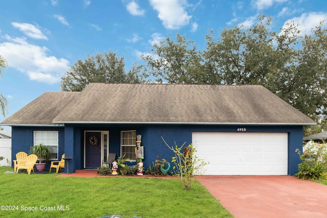 ranch-style home with a garage and a front lawn