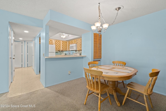 997 Sonesta Ave NE Unit 206, Palm Bay, FL 32905 - dining room featuring a textured ceiling, light carpet, a chandelier, and ceiling fan