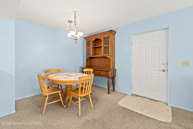 997 Sonesta Ave NE Unit 206, Palm Bay, FL 32905 - dining area with a chandelier, light colored carpet, and a textured ceiling