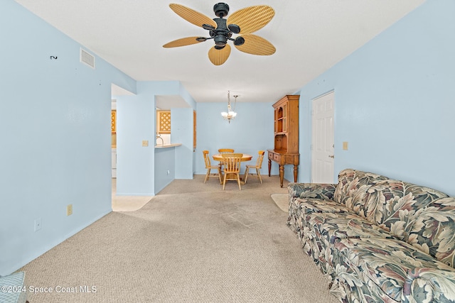 997 Sonesta Ave NE Unit 206, Palm Bay, FL 32905 - living room featuring carpet flooring, ceiling fan, and a chandelier