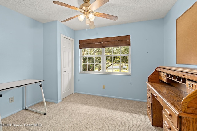 997 Sonesta Ave NE Unit 206, Palm Bay, FL 32905 - home office with light carpet, a ceiling fan, and a textured ceiling
