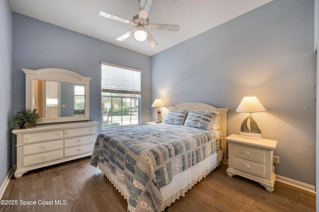 bedroom with dark hardwood / wood-style flooring and ceiling fan