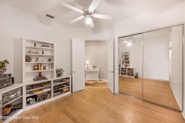 interior space with ceiling fan, a closet, and wood-type flooring