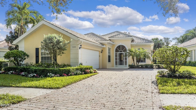 mediterranean / spanish house featuring a garage